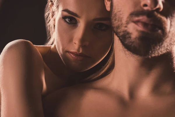 Sensual lovers embracing and looking at camera, on brown — Stock Photo