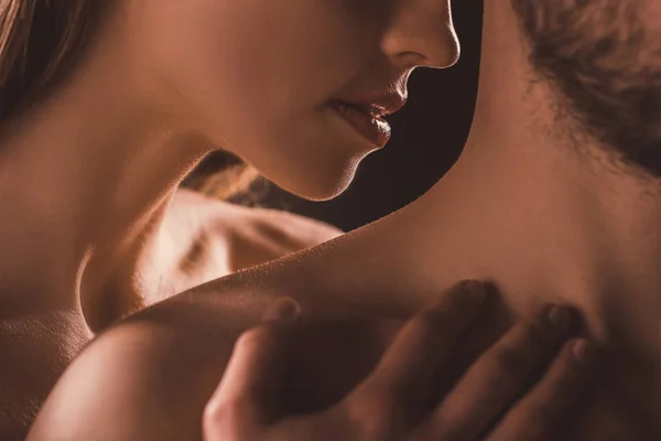 Cropped view of sensual couple, on brown — Stock Photo