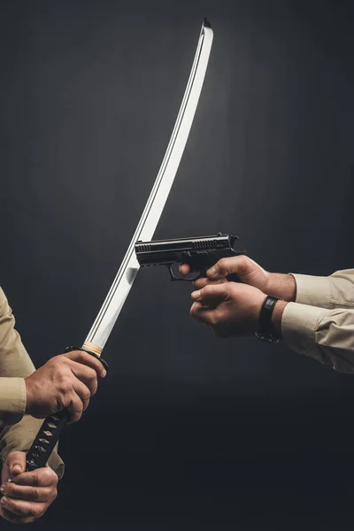 Yakuza members fighting with gun and katana sword on black — Stock Photo