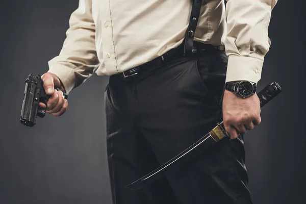 Cropped shot of yakuza member with tanto knife and gun — Stock Photo