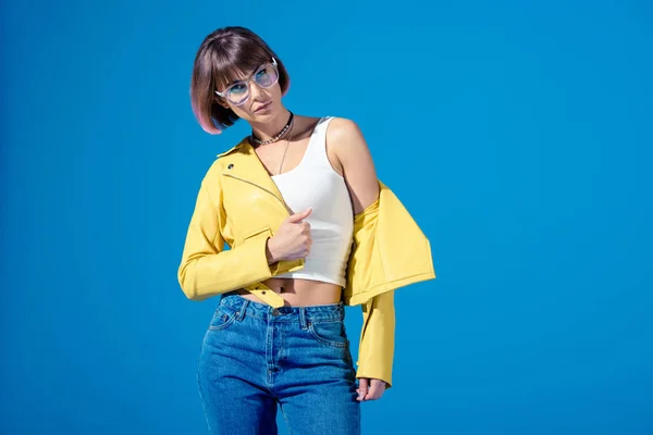 Girl in fashionable clothes posing isolated on blue — Stock Photo