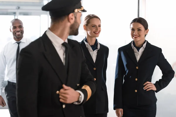 Pilot and his team spending time in airport before flight — Stock Photo