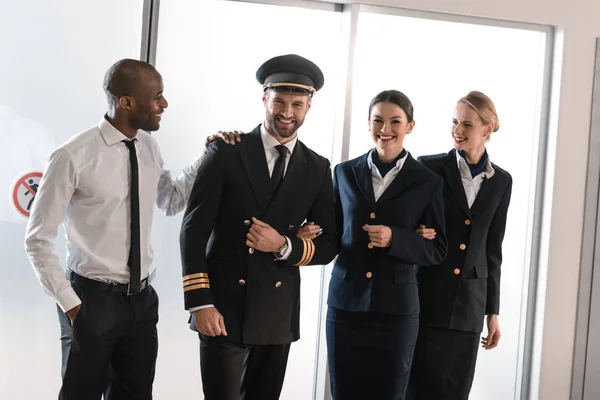 Happy aviation personnel team in professional uniform — Stock Photo