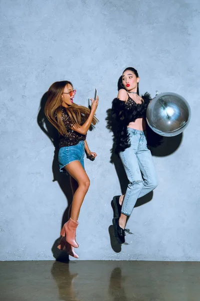 Bella africano americano ragazza con smartphone fotografare asiatico amico avendo divertimento con palloncino a festa — Foto stock