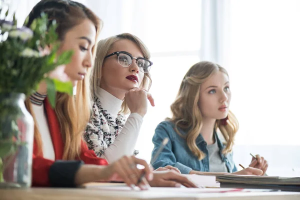 Multicultural magazine editors working with color palette in modern office — Stock Photo