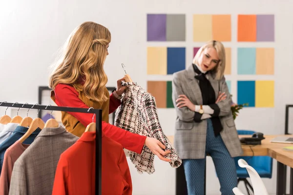 Modische Zeitschriftenredakteure arbeiten mit Kleidung im modernen Büro — Stockfoto