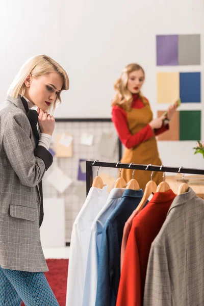 Fashionable magazine editor working with clothes in modern office — Stock Photo