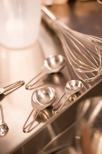 Close up view of kitchen utensils on metal counter in restaurant — Stock Photo