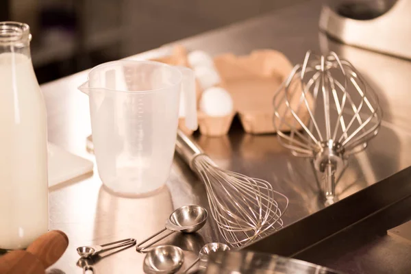 Close up view of ingredients for dough and kitchen utensils on counter in restaurant — Stock Photo