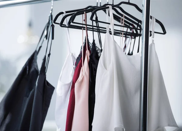 Close-up shot of various dresses hanging on rack — Stock Photo