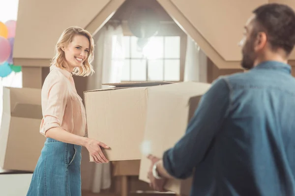 Back view of couple moving into new cardboard house — Stock Photo