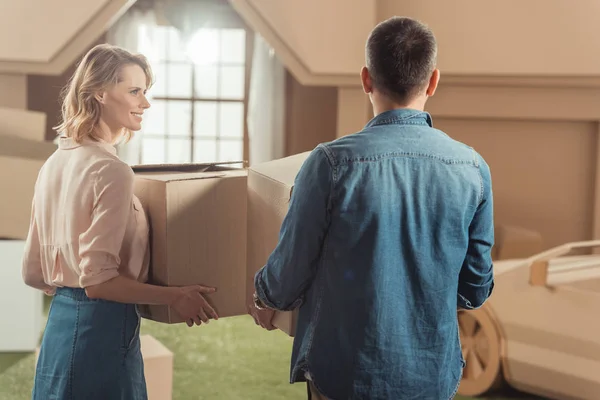 Adult couple moving into new cardboard house — Stock Photo