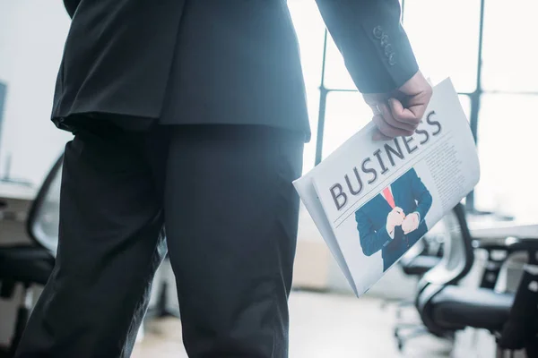 Partial view of businessman with newspaper in hand in office — Stock Photo