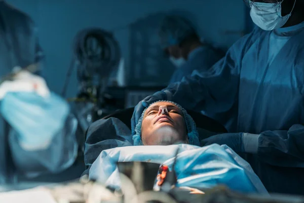 Female patient at surgery in operating room — Stock Photo