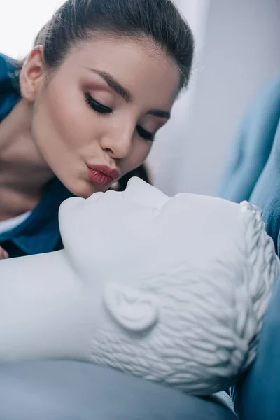 Close up view of woman kissing mannequin in bed, one way love concept — Stock Photo