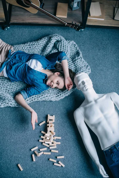 Overhead view of woman and mannequin lying on floor near blocks wood game, perfect relationship dream concept — Stock Photo