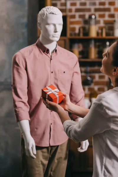 Partial view of woman pretending to except gift from mannikin, loneliness and perfect man dream concept — Stock Photo