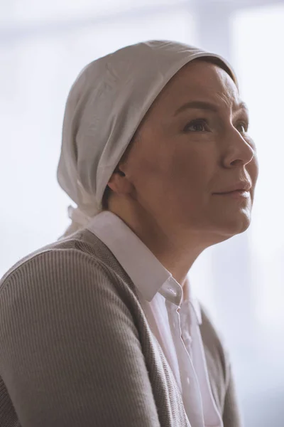 Portrait of sick mature woman in kerchief looking away — Stock Photo