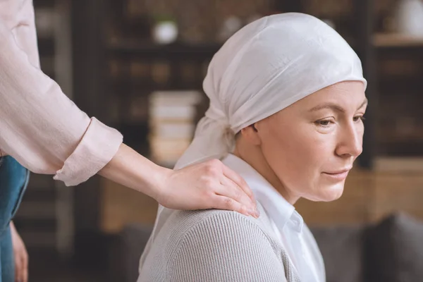 Cropped shot of woman supporting sick upset mature mother in kerchief — Stock Photo