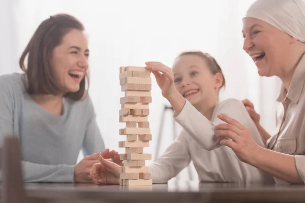 Happy family playing with wooden blocks together, cancer concept — Stock Photo