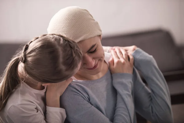 Child hugging and supporting sick mother in kerchief — Stock Photo