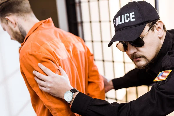 Prison officer leading convict in handcuffs — Stock Photo