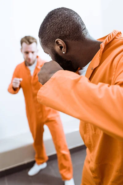 Multiethnic prisoners fighting in prison cell — Stock Photo