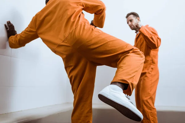 Multicultural prisoners fighting in prison cell — Stock Photo