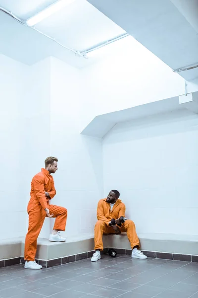 Multiethnic prisoners in light modern prison cell — Stock Photo