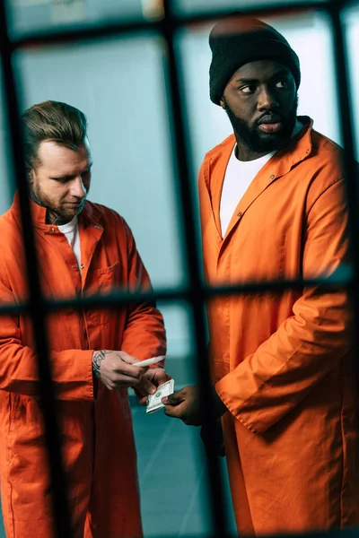 Criminal buying drugs at african american prisoner in prison cell — Stock Photo