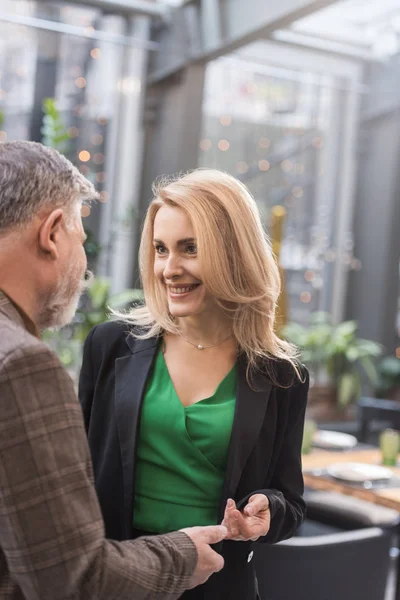 Partial view of smiling woman and man looking at each other in cafe — Stock Photo