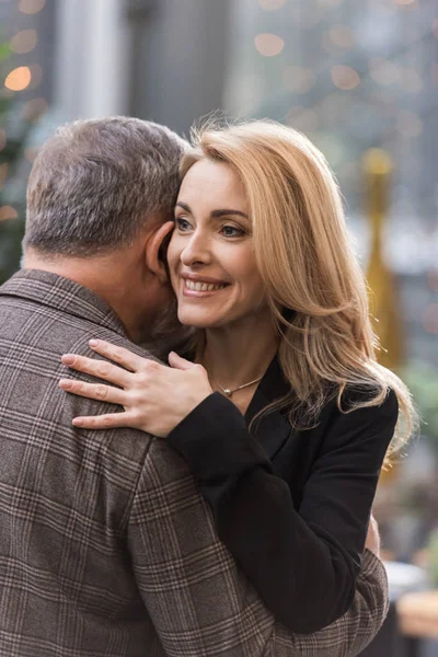 Partial view of smiling woman and man hugging each other — Stock Photo