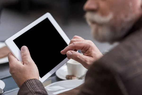 Partial view of businessman with tablet with blank screen in cafe — Stock Photo