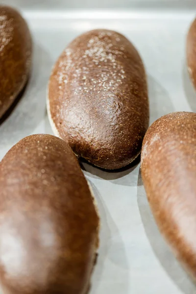Close-up shot of rye buns on baking tray — Stock Photo
