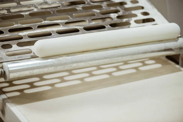 Close-up shot of industrial dough roller — Stock Photo