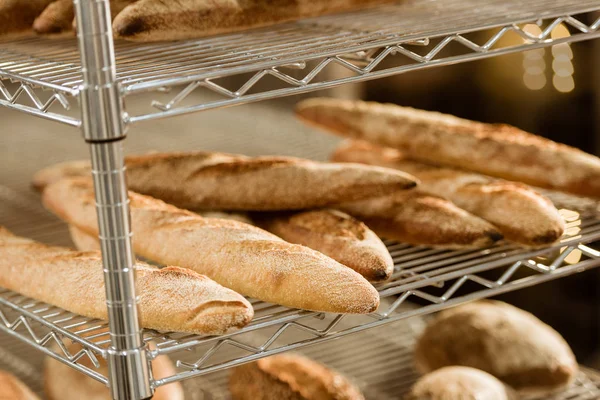 Shelves with freshly baked bread on baking manufacture — Stock Photo
