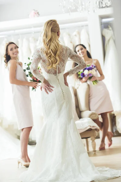 Mujeres felices en vestidos de novia en la tienda de moda de boda - foto de stock