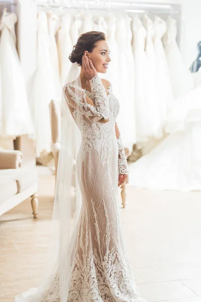 Young bride in white dress in wedding fashion shop — Stock Photo