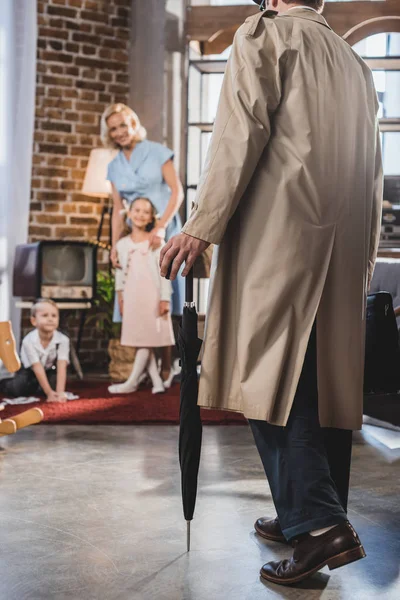 Cropped shot of father coming home and looking at happy family, 1950s style — Stock Photo