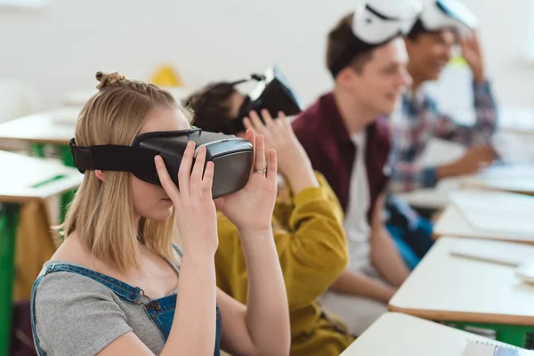 Side view of high school students taking off virtual reality headsets — Stock Photo