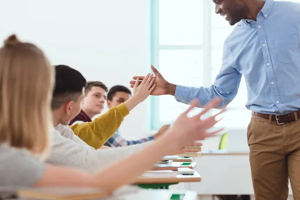 Cropped image of african american taking high five to multicultural high school teenage students — Stock Photo