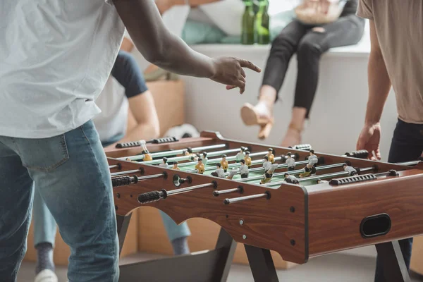 Cropped image of man pointing by finger on table football board — Stock Photo