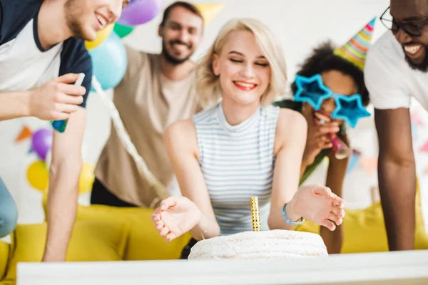 Young multiracial people celebrating with birthday cake — Stock Photo