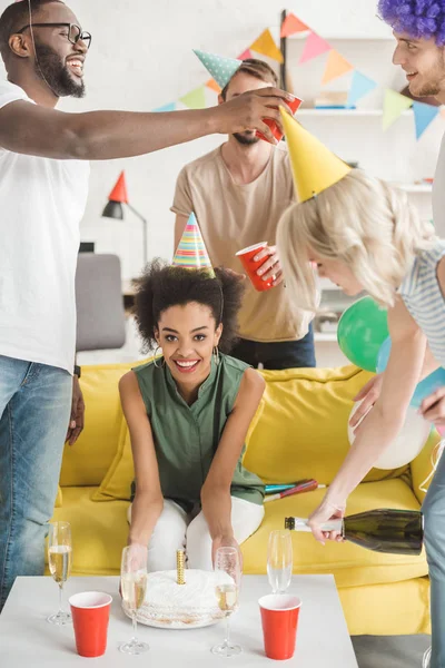 Young joyful male and female friends celebrating birthday — Stock Photo