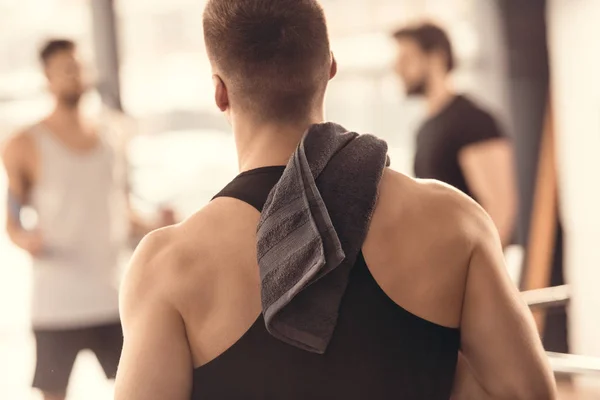 Back view of muscular sportsman with towel on shoulder — Stock Photo