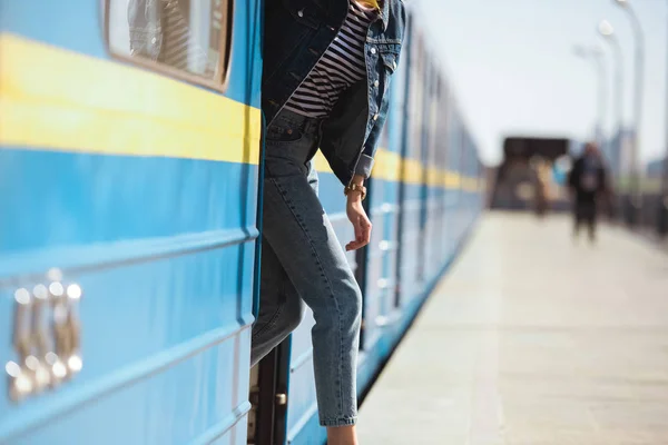 Tiro cortado de mulher elegante saindo do trem na estação de metrô ao ar livre — Fotografia de Stock