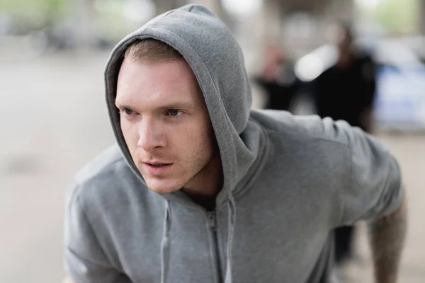 Close-up shot of young hooded thief running from police — Stock Photo