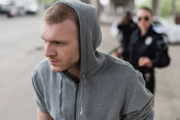 Close-up shot of young thief running from police — Stock Photo