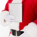 Santa Claus poseren met de digitale tablet