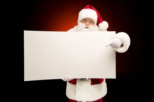 Santa Claus pointing on blank card — Stock Photo, Image